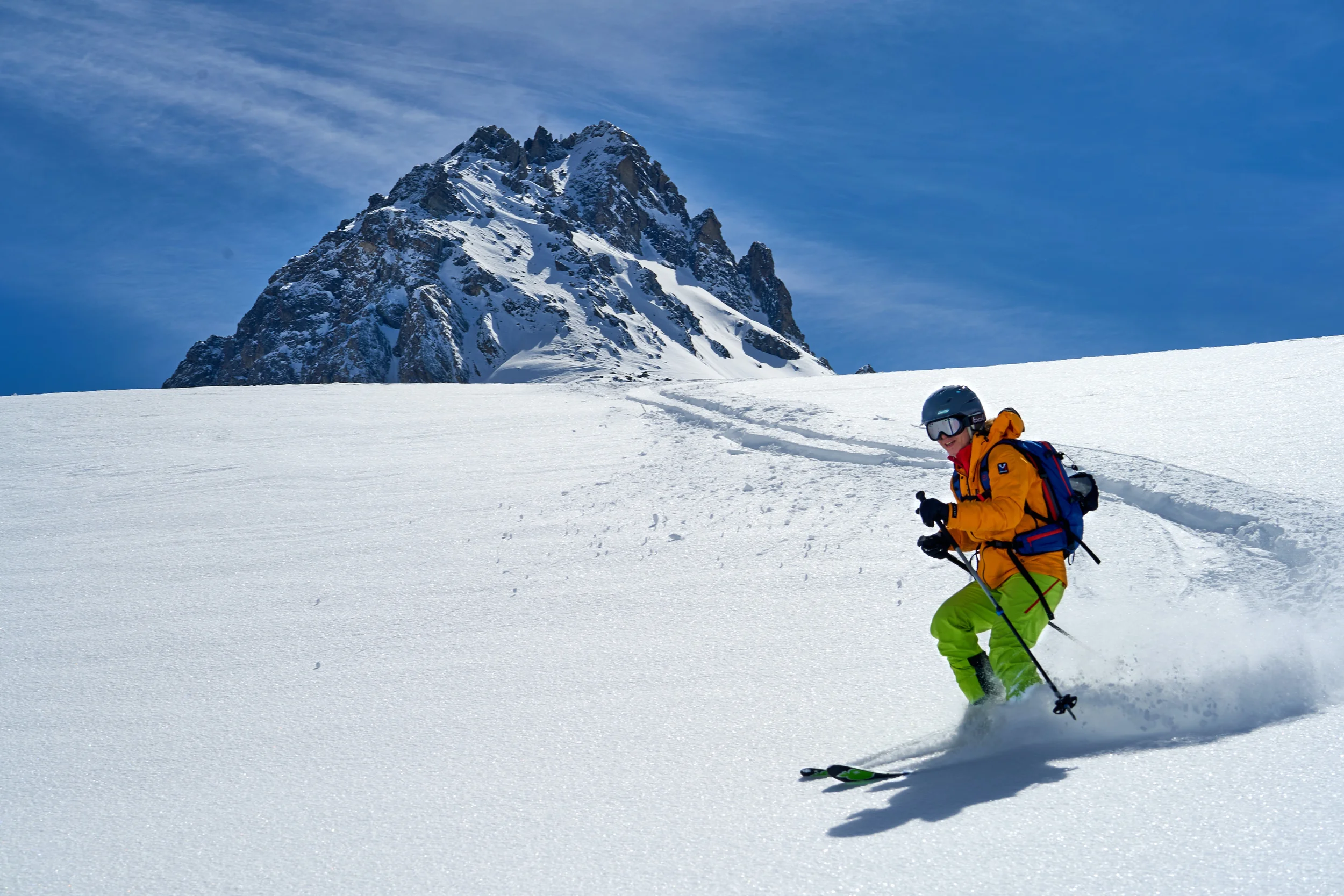 Skier riding down a mountain slope